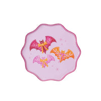 Product shot of one pink scalloped dinner plate with three bats and bows on a white background.
