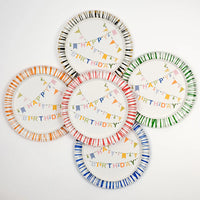 five Happy Birthday plates arranged in a circle showing striped rims in black, green, orange, red, and blue.