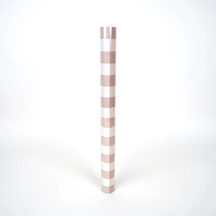 Brown gingham paper table runner shown rolled as a tube for size reference.