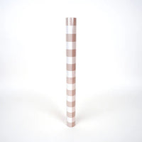 Brown gingham paper table runner shown rolled as a tube for size reference.