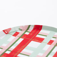 Angle detail of cheerful plaid plate highlighting glossy red stripes and green accents.