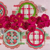 Decorative plates with plaid and polka dot patterns surrounded by pink flowers on a matching background.