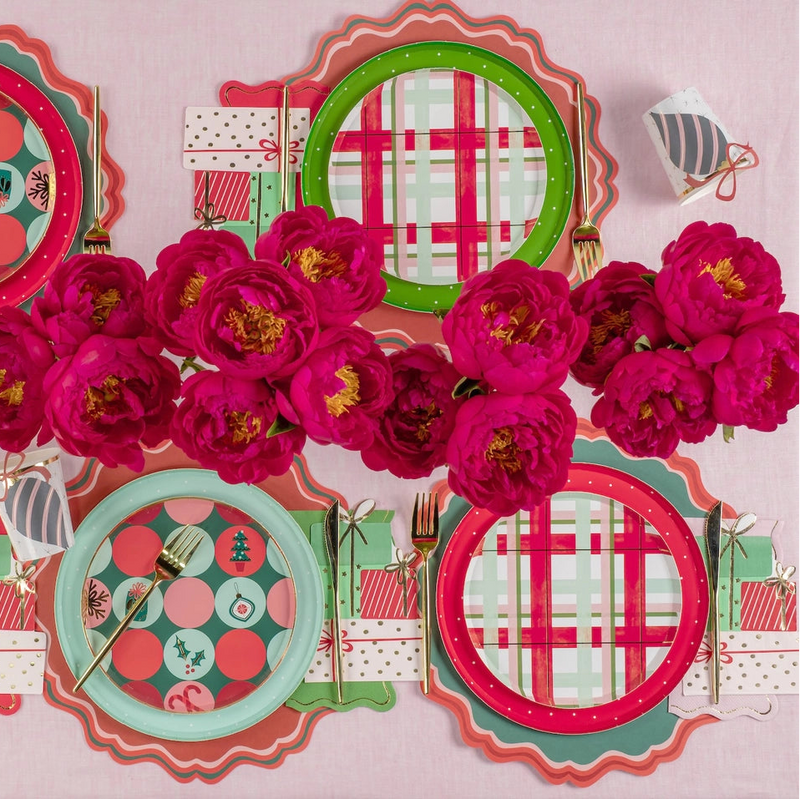 Decorative plates with plaid and polka dot patterns surrounded by pink flowers on a matching background.