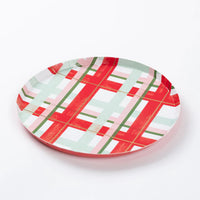 Three-quarter view of a single cheerful plaid small plate on white background.