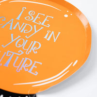 Edge detail of the crystal ball plate showing glossy finish and foil lettering on orange.