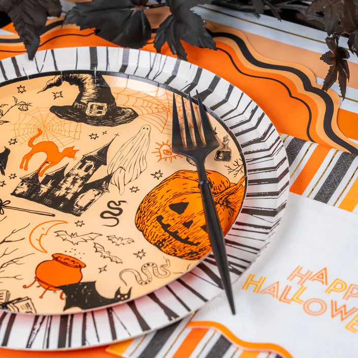 Detail of jack o lantern section on the icon plate with black fork and striped rim plate below.