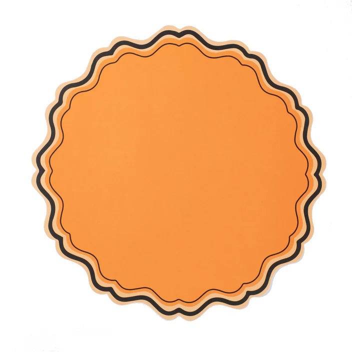 Single orange scalloped paper placemat with layered black and peach border on white background.