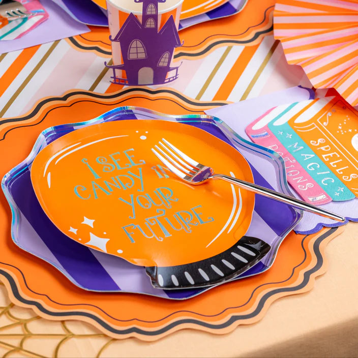 Place setting with orange quote plate over purple striped plate on an orange scalloped placemat.