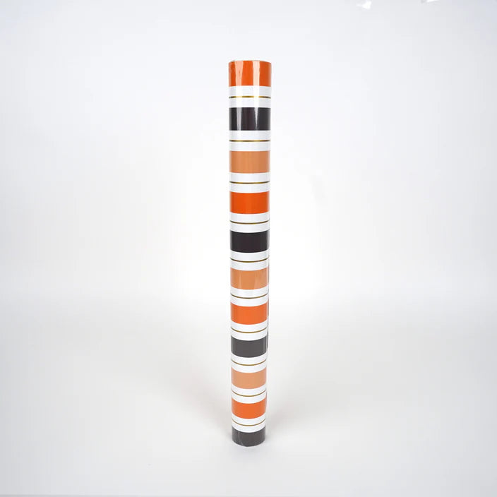 Product shot of Halloween stripe paper table runner rolled in a tube.