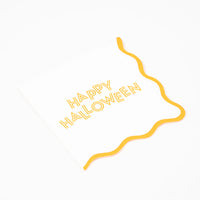 Single Happy Halloween napkin unfolded showing scalloped orange border.