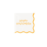 Close view of tablescape showing Happy Halloween cocktail napkin next to black goblet and leaves.