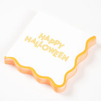 Angled stack of Happy Halloween scalloped cocktail napkins on white background.