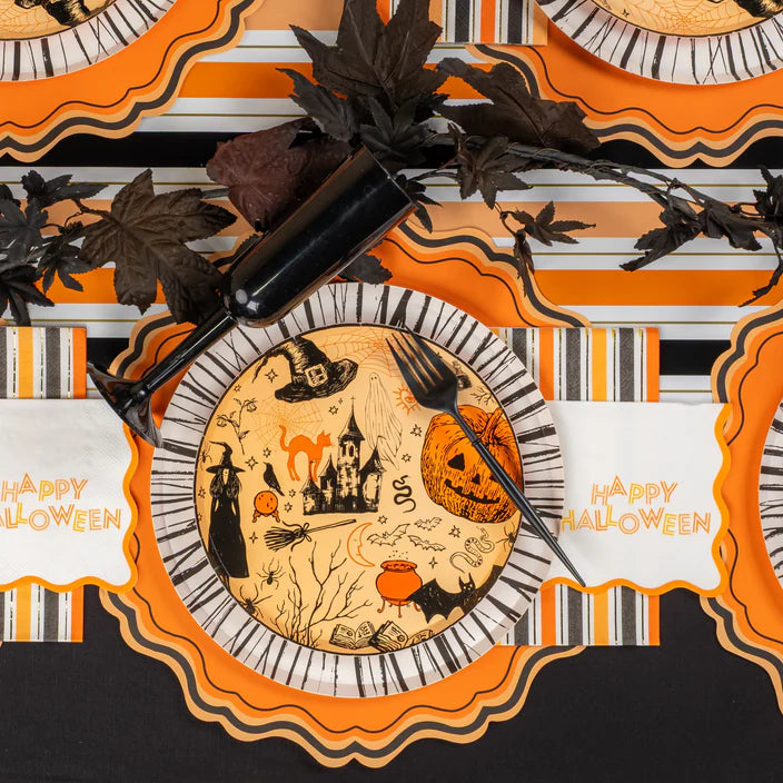 Overhead place setting with vintage icon plate and Happy Halloween cocktail napkin.