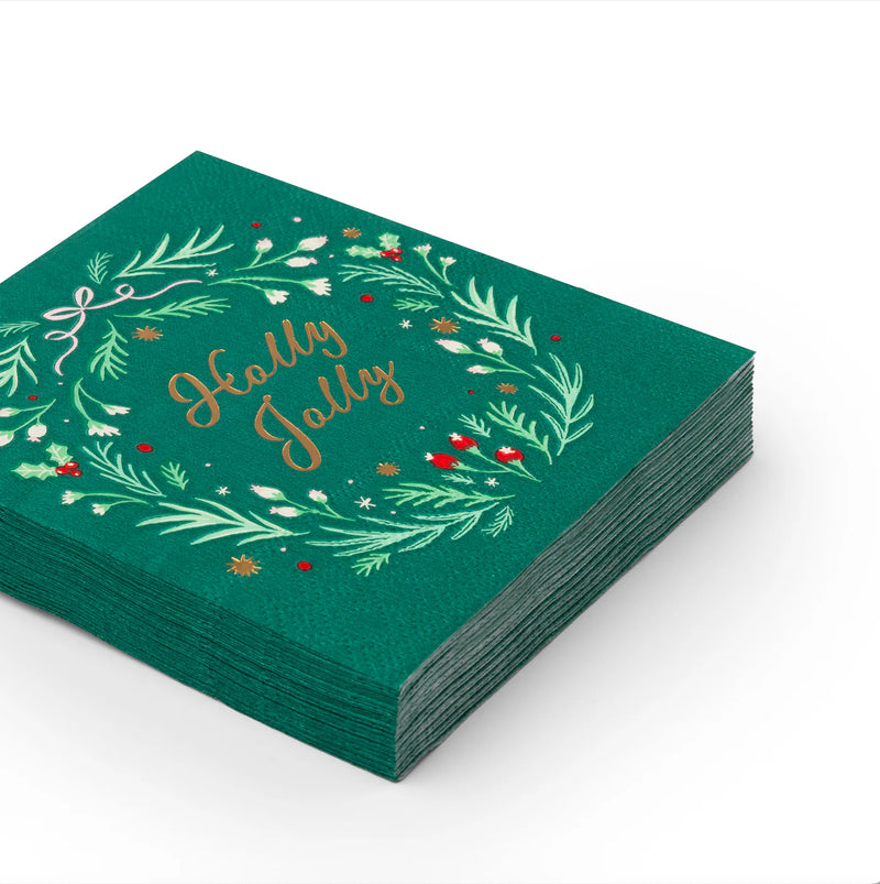 Stack of emerald green cocktail napkins with wreath and “Holly Jolly” script