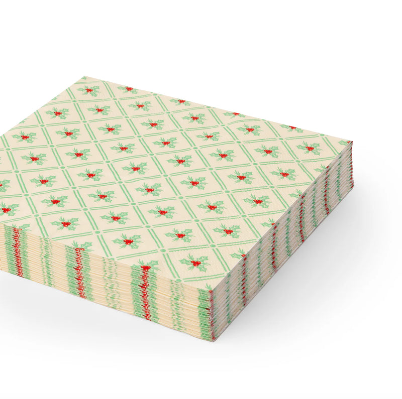 Stack of holly-patterned lunch Christmas paper napkins with green lattice and red berries