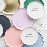 Assorted plate stack with lilac plate among pastel party plates
