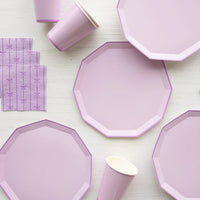Closeup group of lilac plates with matching cups and purple paper napkins
