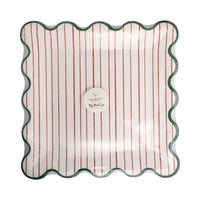 Front of packaged Mrs. Claus Bakery square Christmas paper plates with red pinstripes and green border