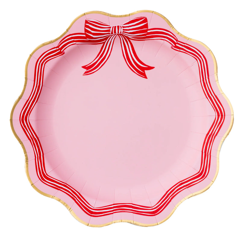 Front view of pink scalloped dinner plate with red bow and gold rim scalloped edge plates