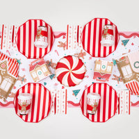 Gingerbread scene with wide-stripe cabana red paper plates set at each place setting