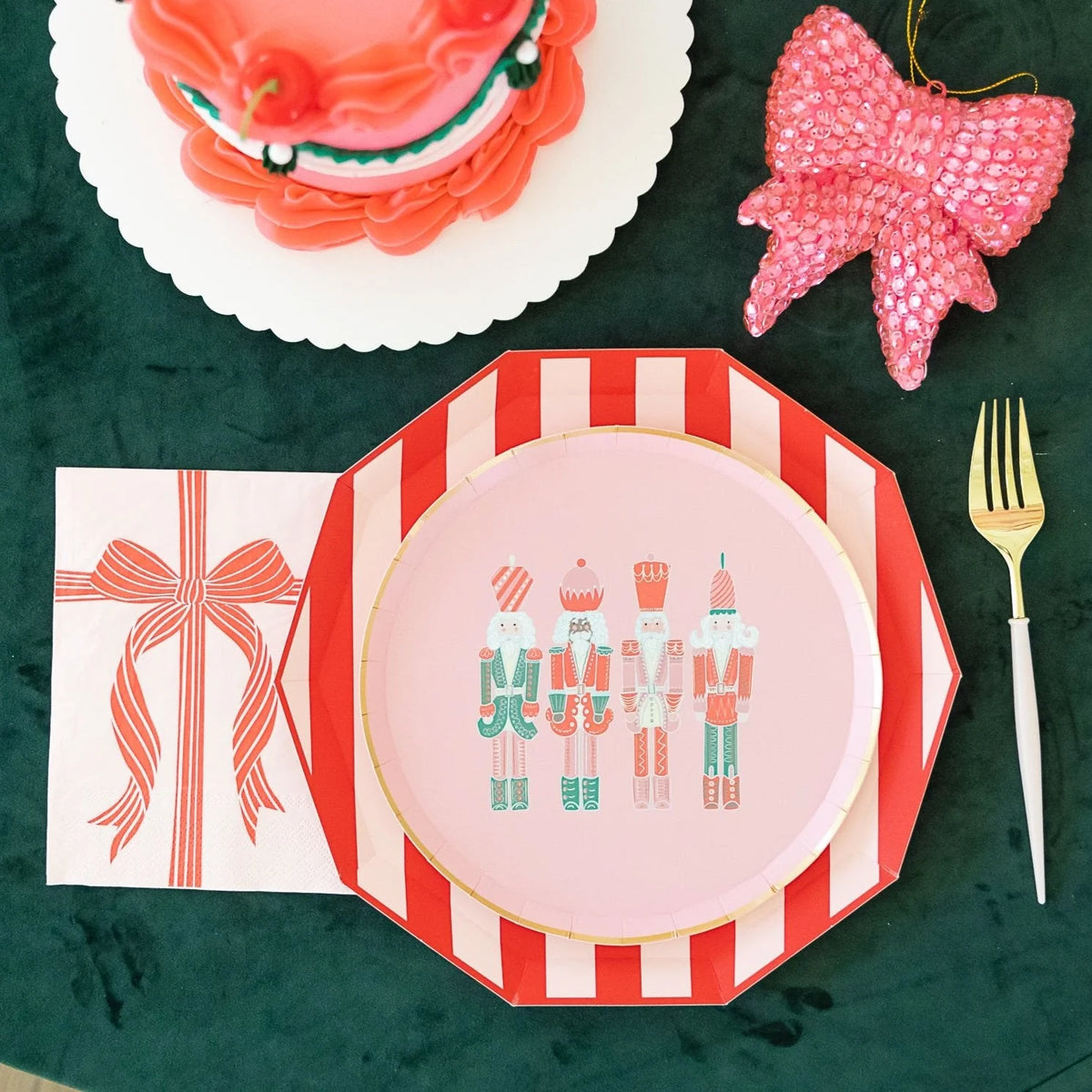 Cabana red paper plates layered under pink nutcracker dessert plate