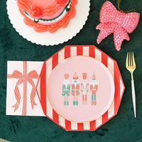 Cabana red paper plates layered under pink nutcracker dessert plate