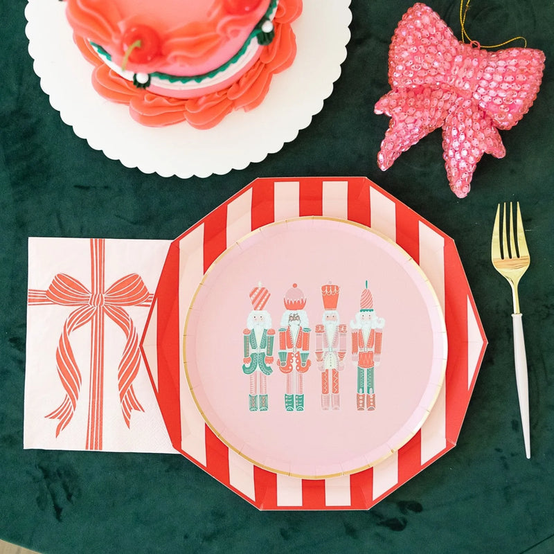 Cabana red paper plates layered under pink nutcracker dessert plate