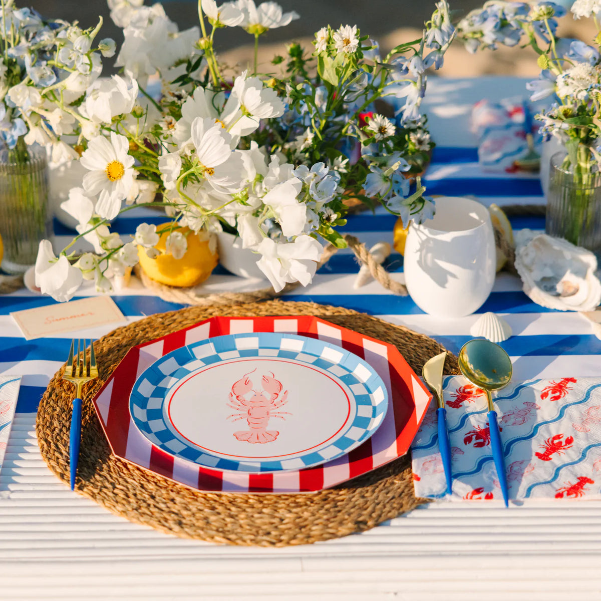 Nautical table with lobster salad plate layered on cabana striped dinner plates