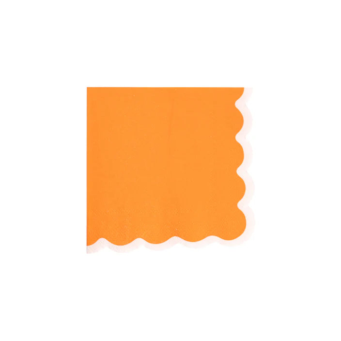 Single orange cocktail napkin with white scalloped border on white background.
