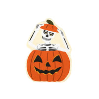 Product image of the skeleton popping out of a jack o lantern die cut napkin on white background.