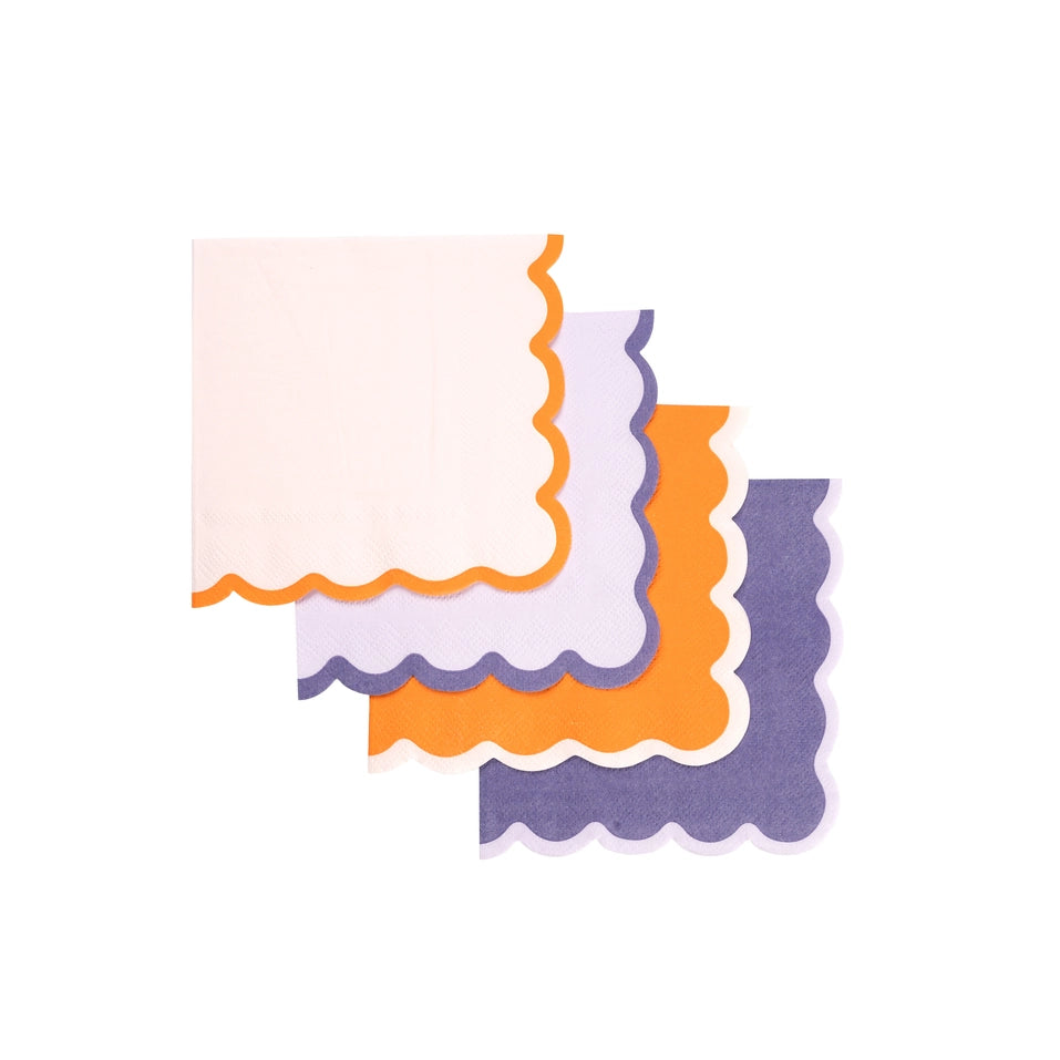 Set of four scalloped cocktail napkins overlapped in purple, lilac, orange, and white.