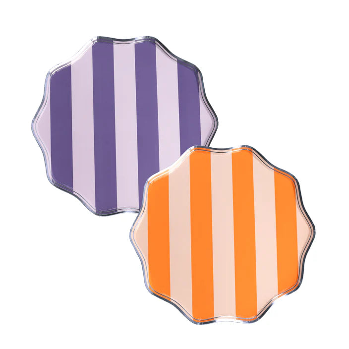 Product image of two striped dinner plates, purple and orange colorways, on white background.