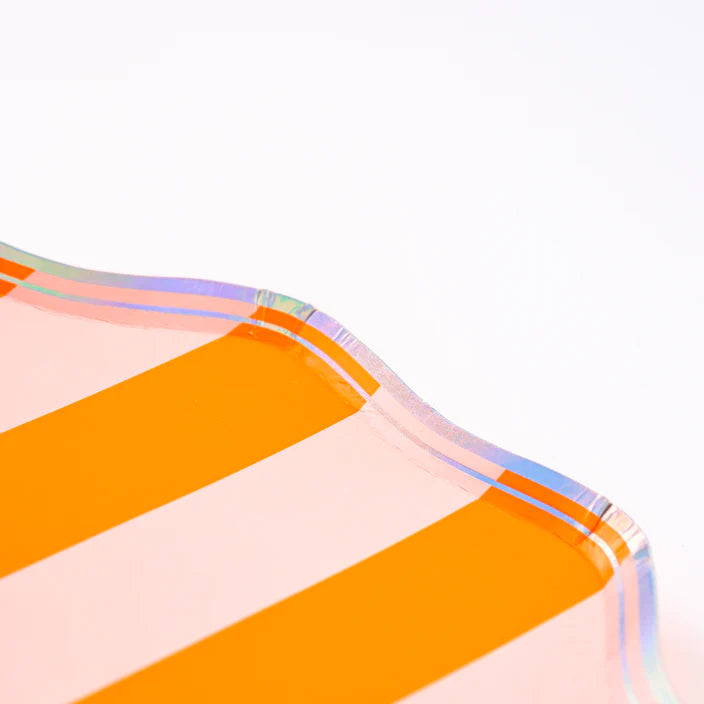 Corner closeup of orange and blush striped dessert plate showing scalloped edge and iridescent trim.