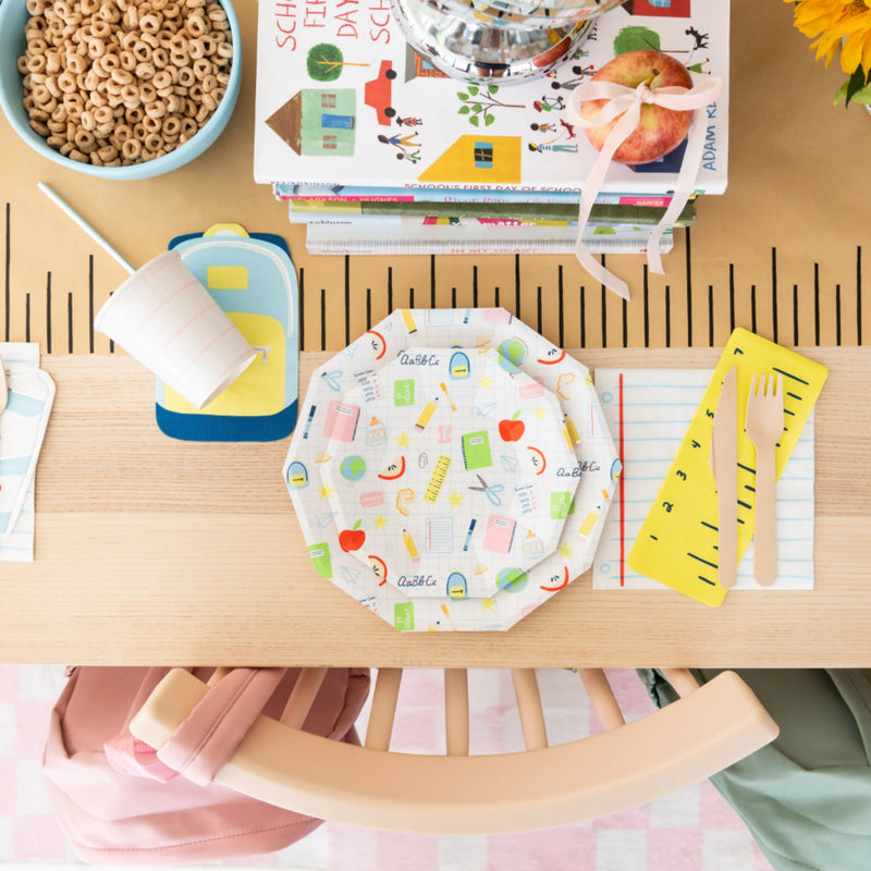 Styled breakfast table featuring Smarty Pants kit plates, napkins, and cereal for first-day party