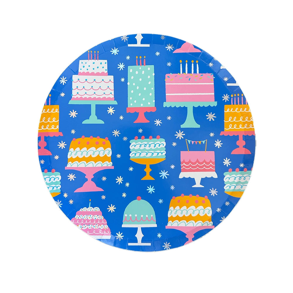 Studio image of 10-inch blue paper plate covered in assorted illustrated birthday cakes on stands
