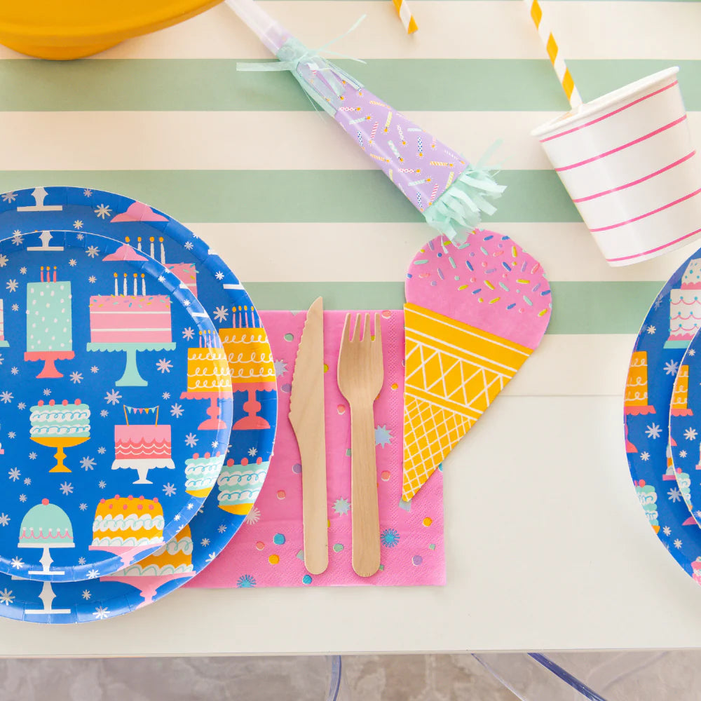 Four 7.5-inch party blowers in pink, lime, blue, and lilac prints with fringe tails, lined up on white background