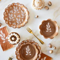 Fall tablescape with acorn plates, napkins, gold flatware, and pies
