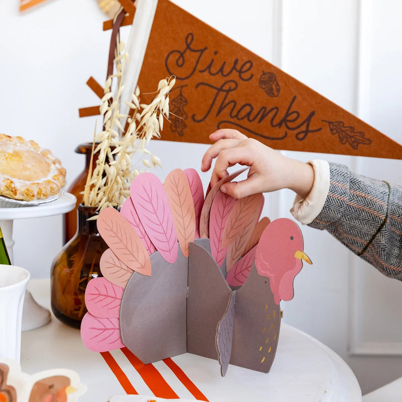 Close up of finished turkey centerpiece with pink and orange feathers