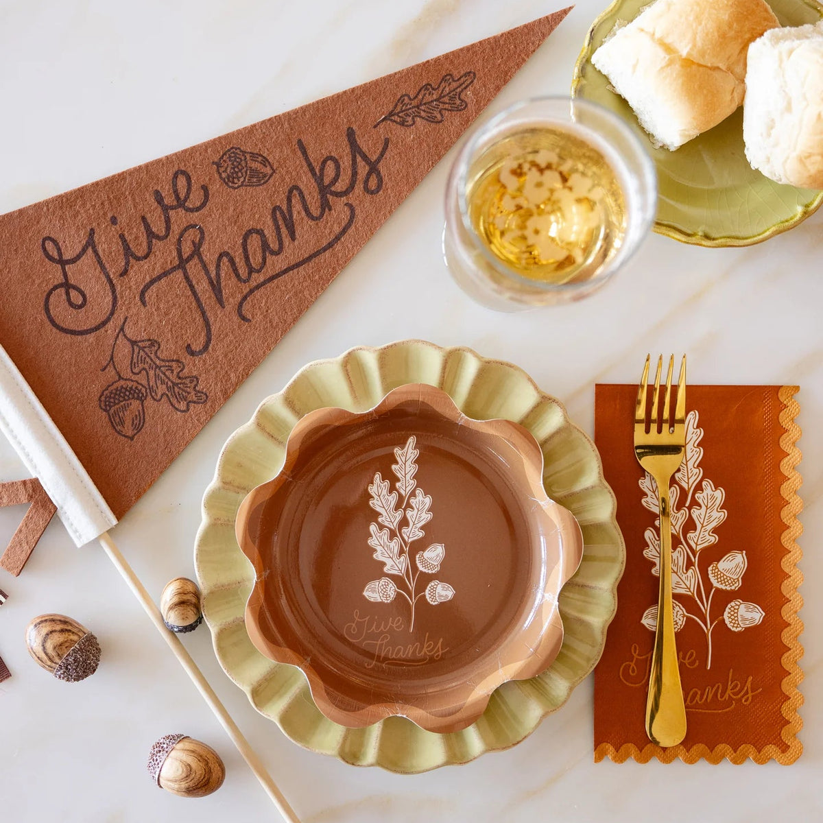 Tablescape with Give Thanks dessert plate, pennant, rolls, and napkin