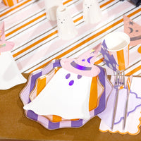 Ghost plate stack and scallop napkin on orange and pink striped runner