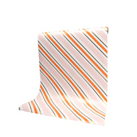 Roll of orange and pink striped paper table runner, draped for display