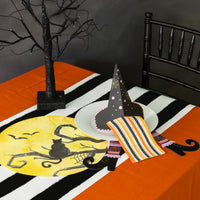 Halloween tablescape with orange stripe halloween paper guest towels on plate