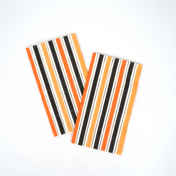 Two orange stripe halloween napkins shown flat on white