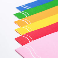 Angle view of rainbow guest towels showing pink, red, yellow, orange, green, blue