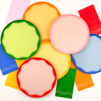 Overhead tablescape with pink guest towels styled beside color block plates