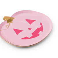 Side stack of pink jack o lantern pumpkin paper plates with gold stems, pretty pink halloween decor