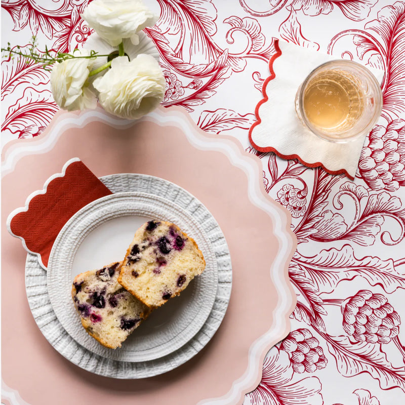 Dessert place setting with cake and blush scalloped paper placemats