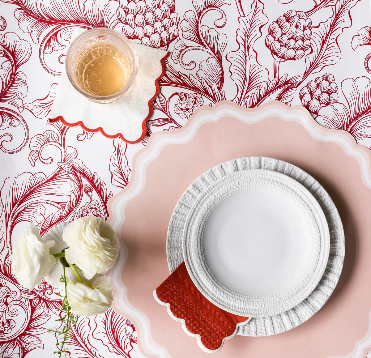 Red toile table styled with blush pink placemats under white dinnerware