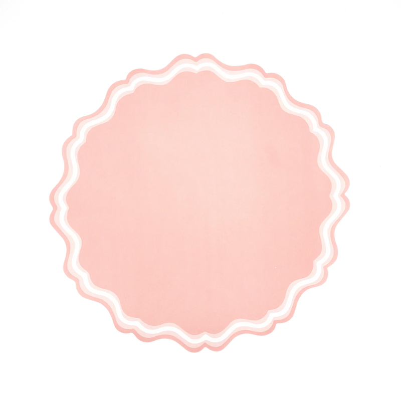 Single blush scalloped pink placemat on white background