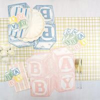 Baby shower blocks runner featuring blush striped paper guest towels